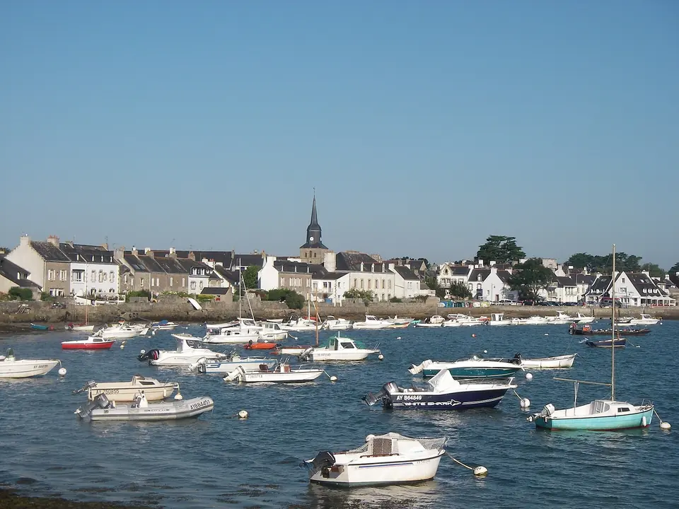 Port de Locmariaquer : bateaux au mouillage devant les maisons du bourg et le clocher.